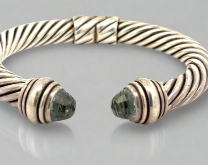 Front of open silver textured bracelet with 2 dome-shaped Prasiolite Gemstones- yellowish green color. Scratches on silver.
