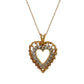 Diamond heart necklace on thin yellow gold chain with diamonds and gold in the heart outline