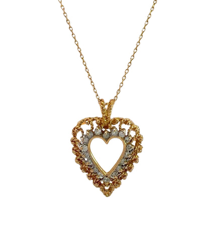 Diamond heart necklace on thin yellow gold chain with diamonds and gold in the heart outline