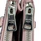 Pictured: Close up of the 2 zippers on the top pockets of the Prada Galleria Crystal mini satin bag in pink. There are very small scratches on the zippers. They say Prada Milano on them.