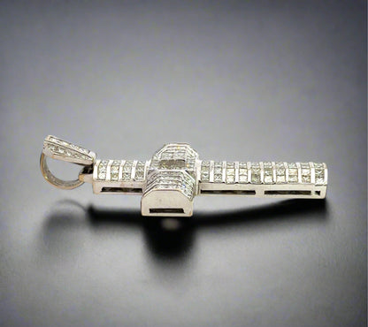Side of white gold cross pendant with marks on the gold