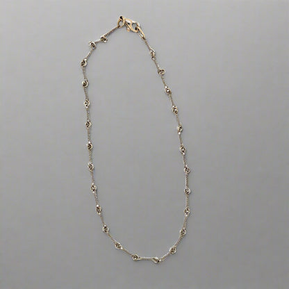 white gold anklet with knot detailing