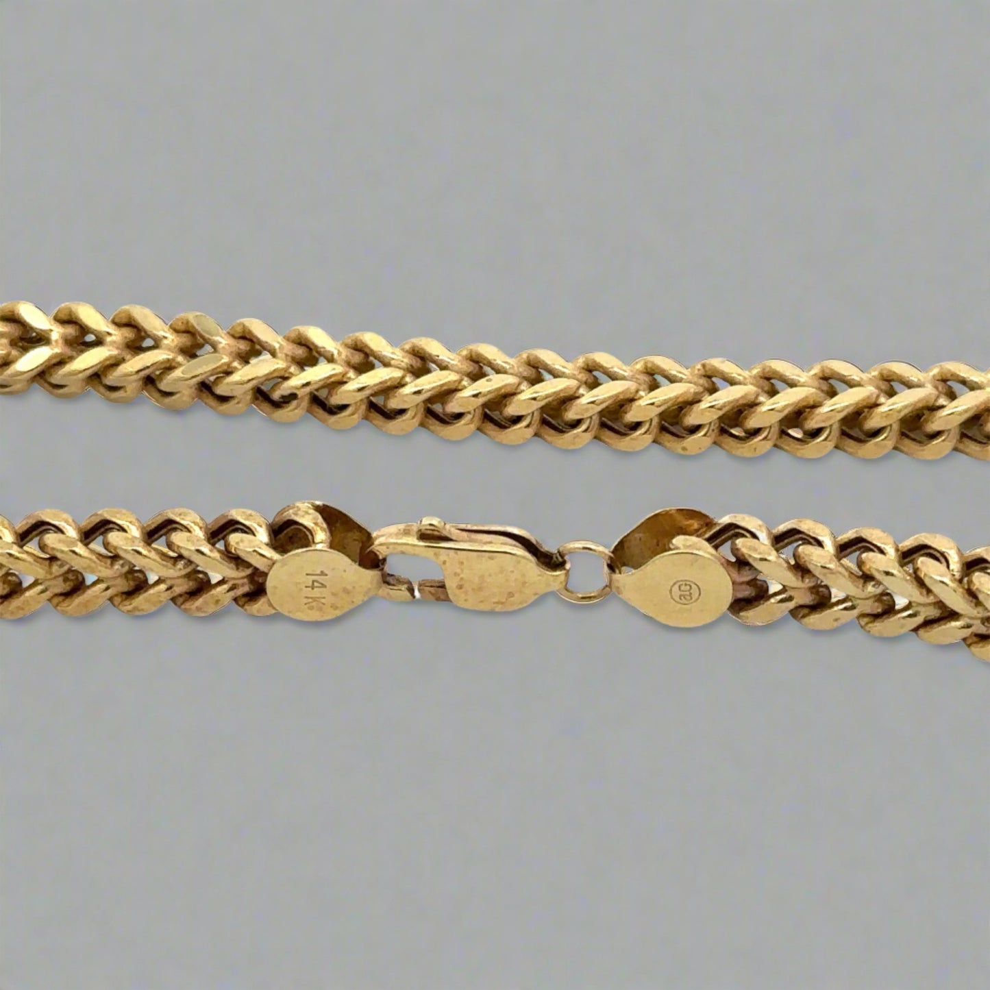 Close up of lobster clasp with 14K stamp and marks on clasp