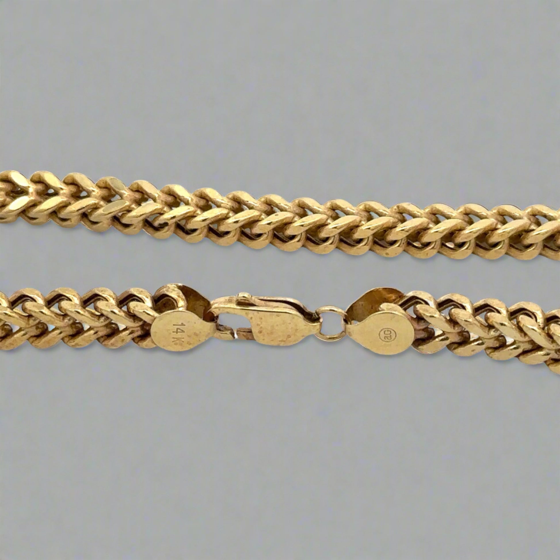 Close up of lobster clasp with 14K stamp and marks on clasp