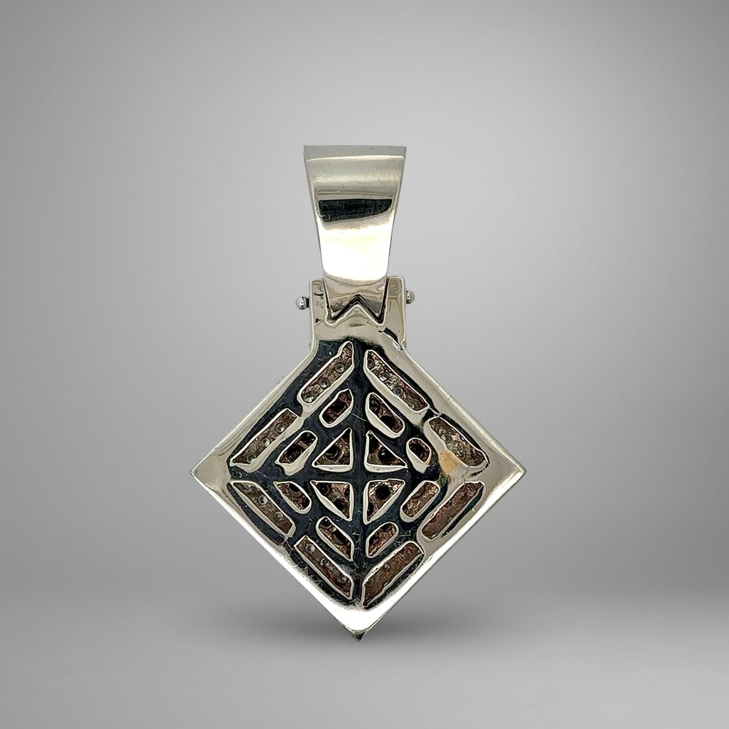 White gold pendant with geometric design on a gray background