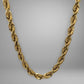 Gold rope chain on a gray background