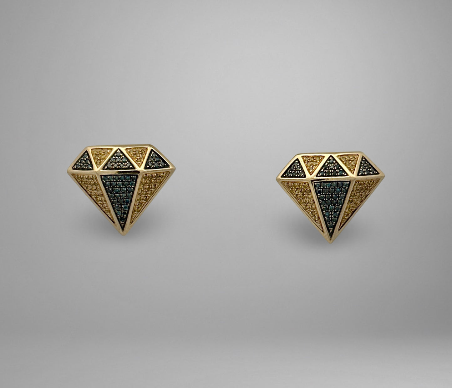 Pair of diamond-shaped earrings with blue and yellow diamonds on a gray background
