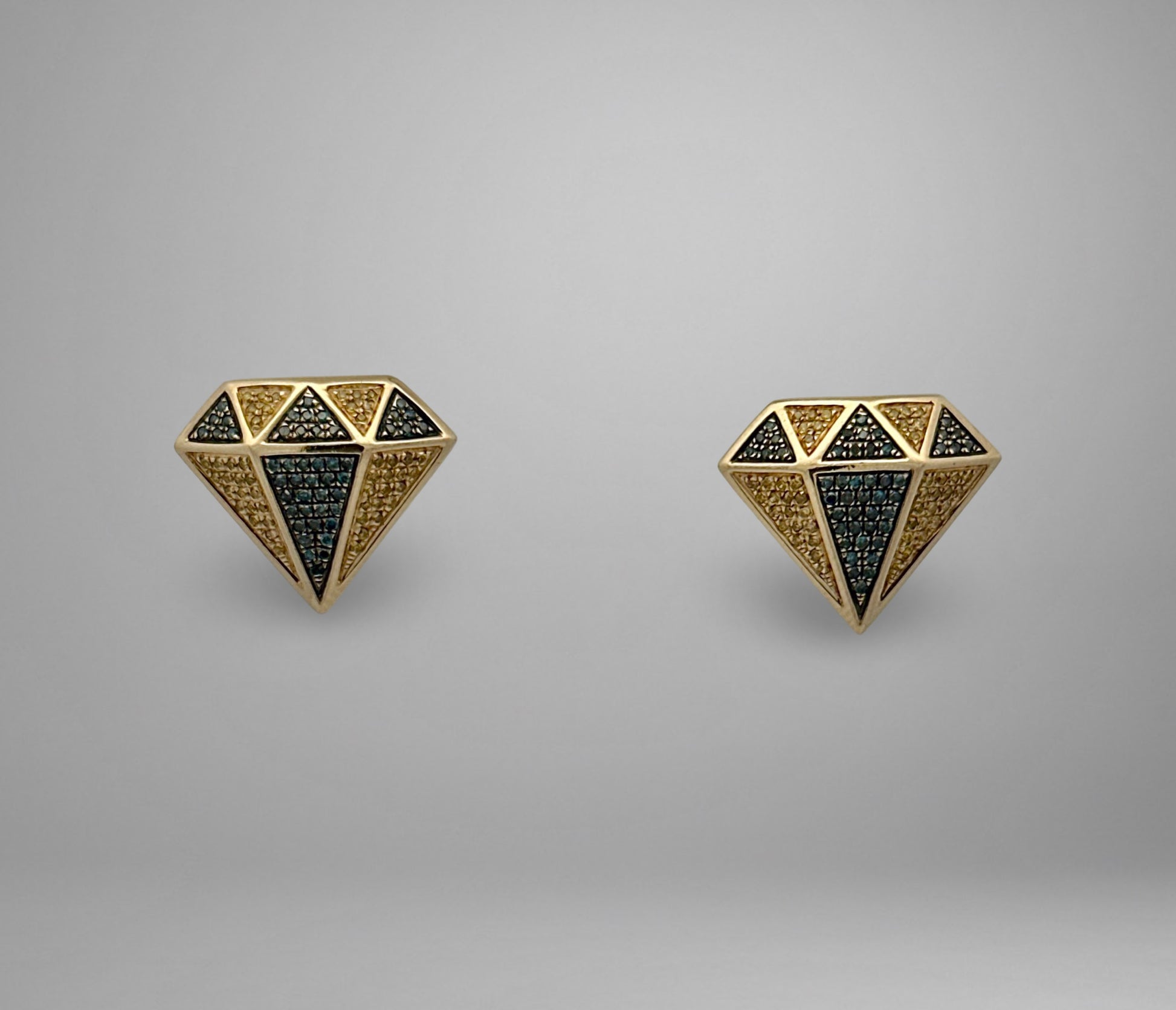 Pair of diamond-shaped earrings with blue and yellow diamonds on a gray background
