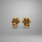 Pair of gold earrings on a gray background