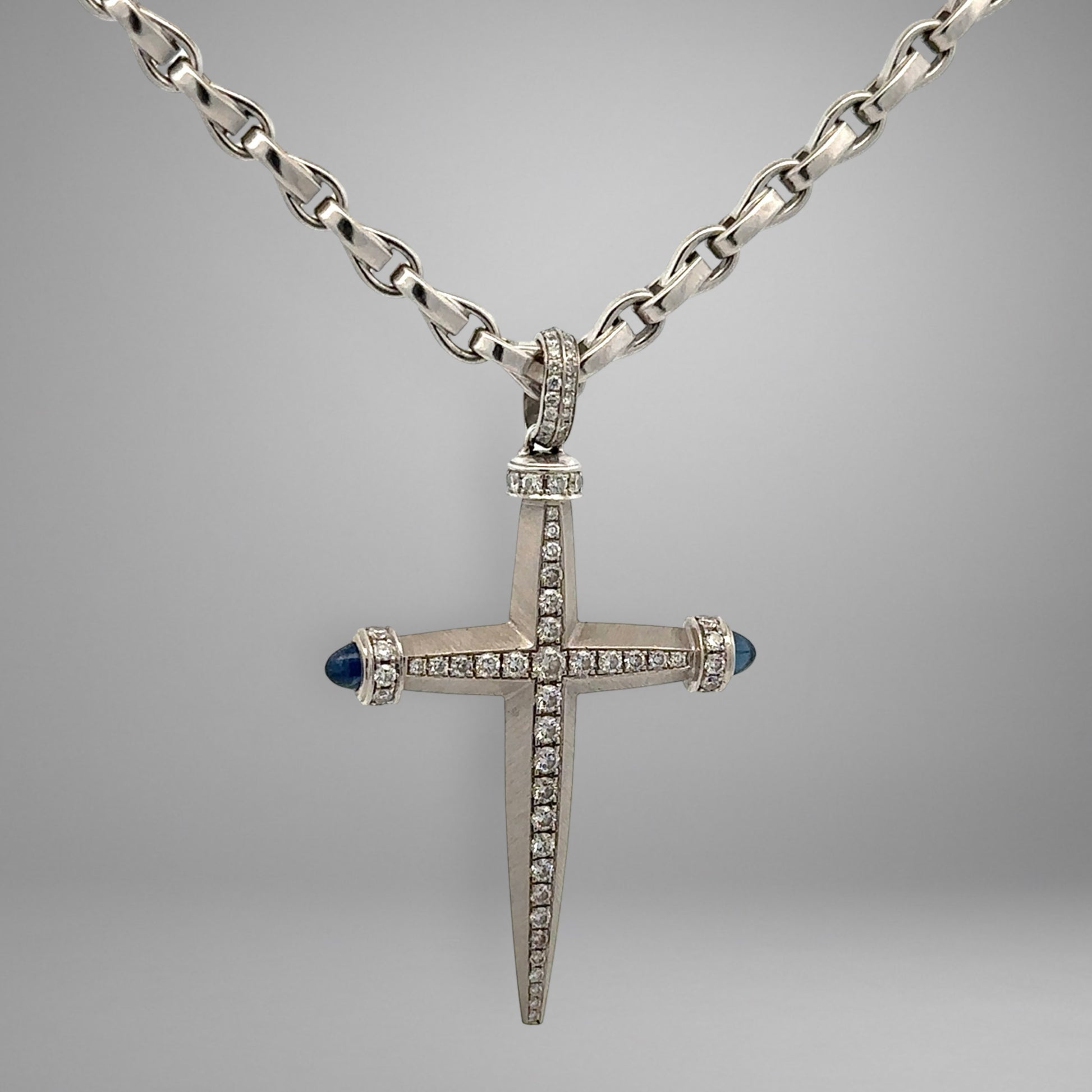 White gold link chain & cross pendant with diamonds and blue gemstones