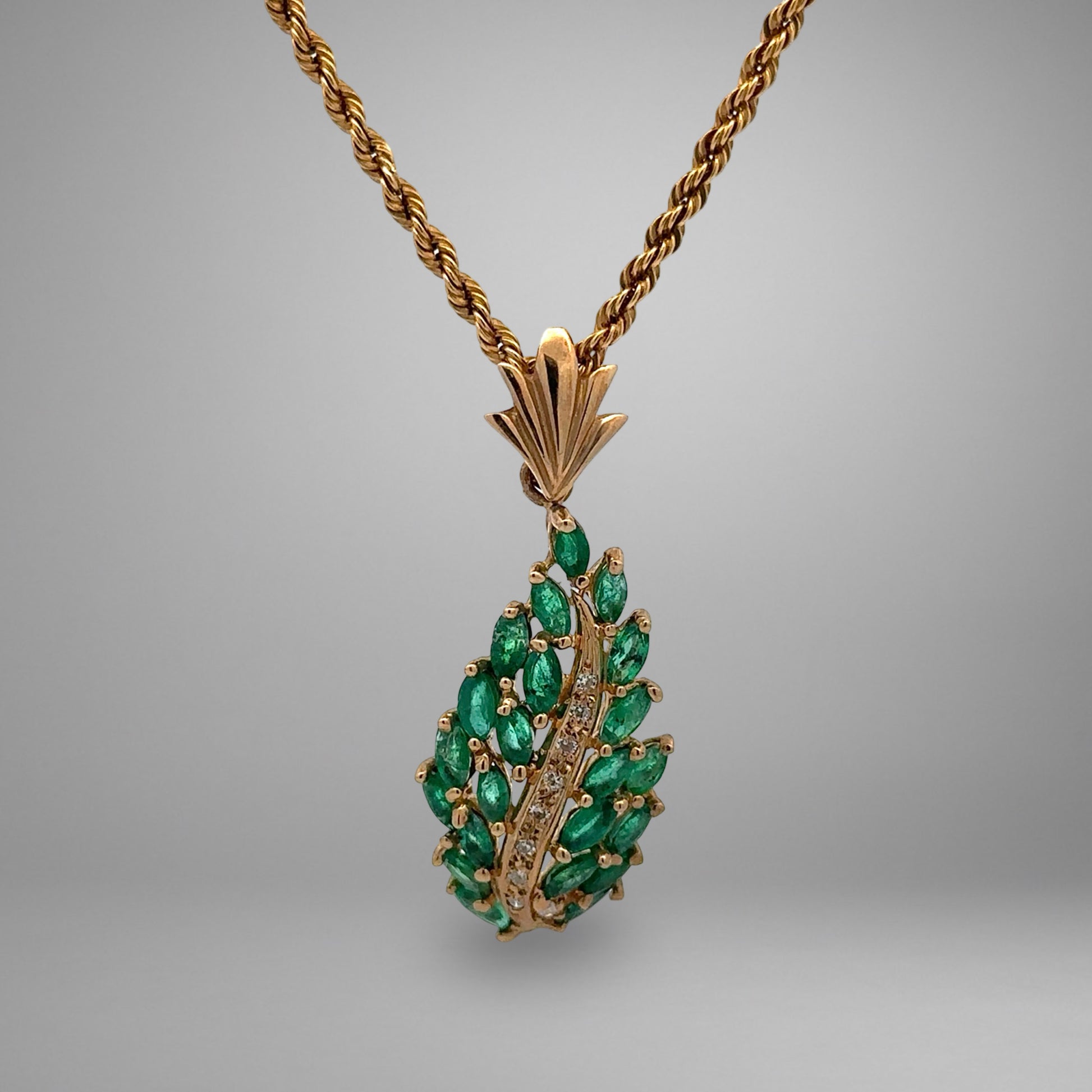 yellow gold necklace with green gemstones and diamonds