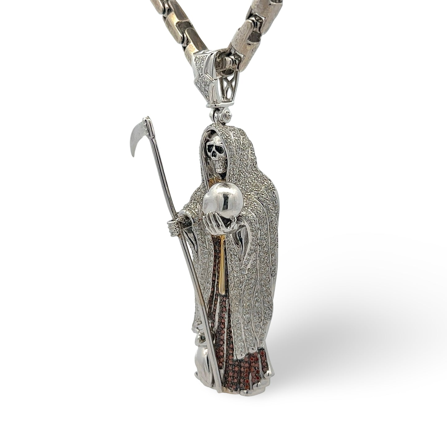 White gold and diamond grim reaper pendant with a chain on a white background