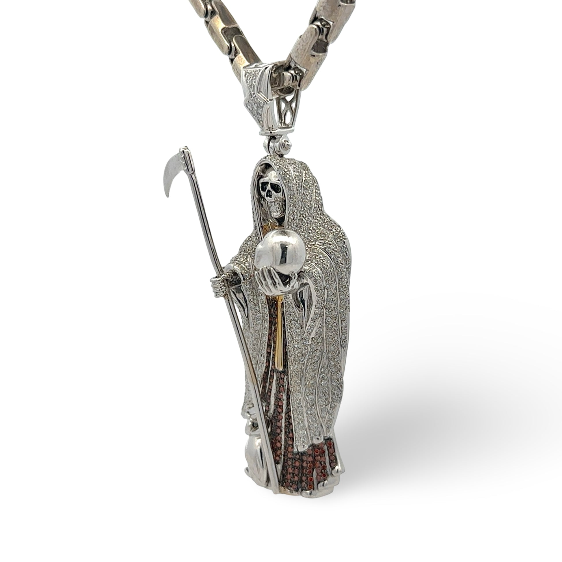 White gold and diamond grim reaper pendant with a chain on a white background