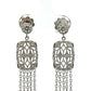 Close up of white gold diamond chandelier earrings
