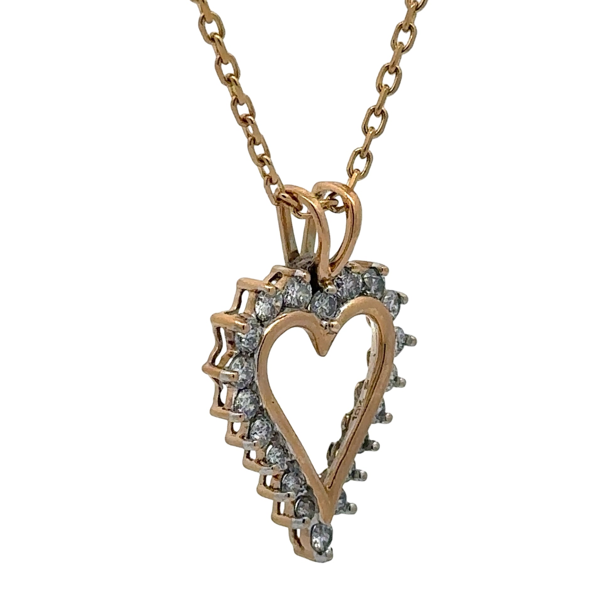 Heart-shaped diamond pendant on a gold chain against a white background