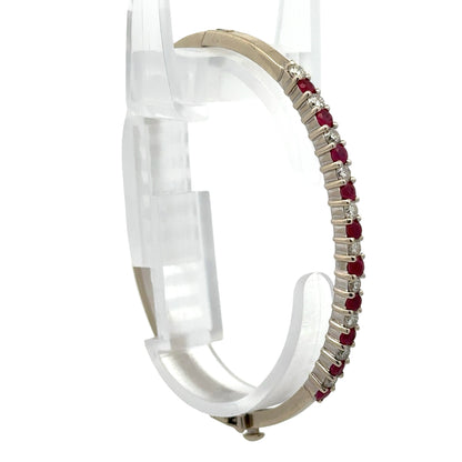 White gold diamond and colored bracelet on a bracelet form