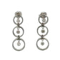 Pair of white gold earrings with multiple circular designs on a white background and floating diamonds inside each circle
