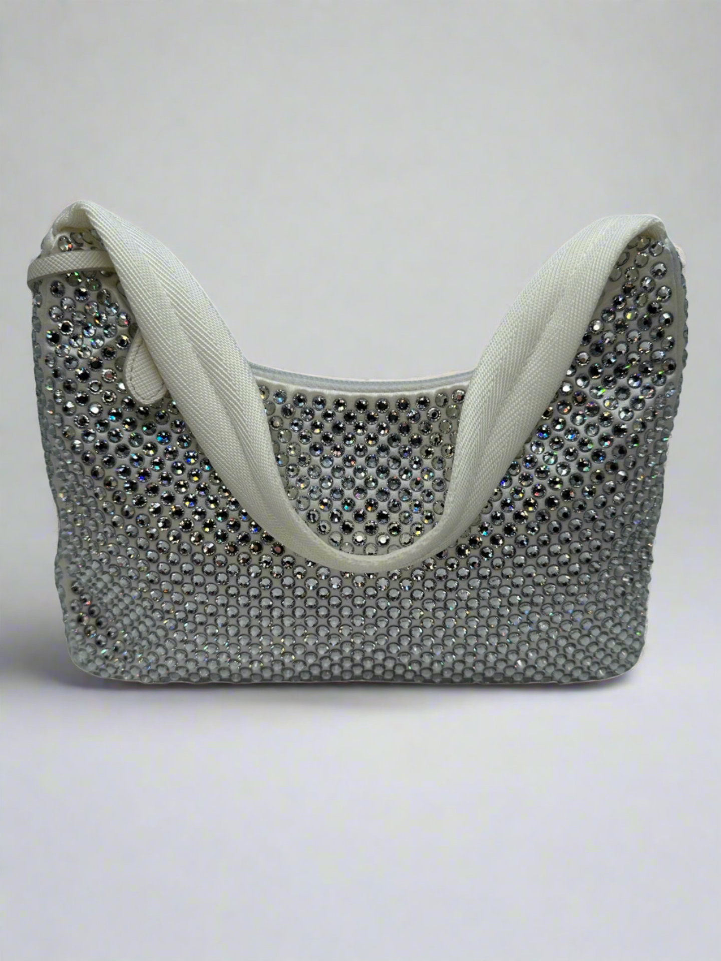 Pictured: The back of the Prada Crystal satin mini bag re-edition in white covered with crystals. No imperfections.