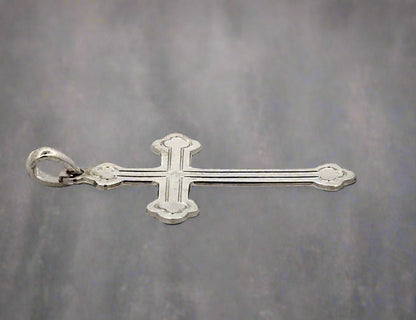 Side view of white gold cross with a small round bail