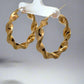 Diagonal view of yellow gold thick twist hoops