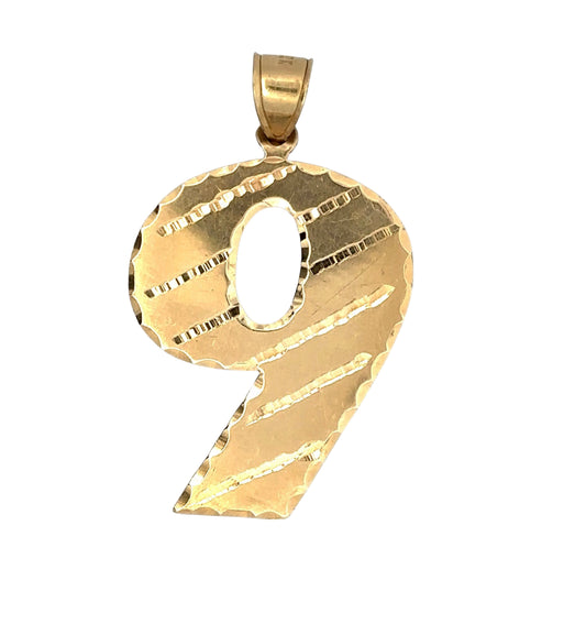 Front of yellow gold 9 pendant showing scratches on gold from handling