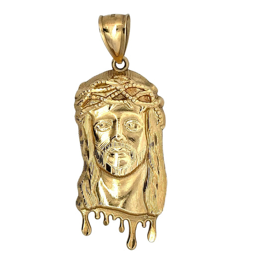 Front of yellow gold jesus head pendant with drips on bottom