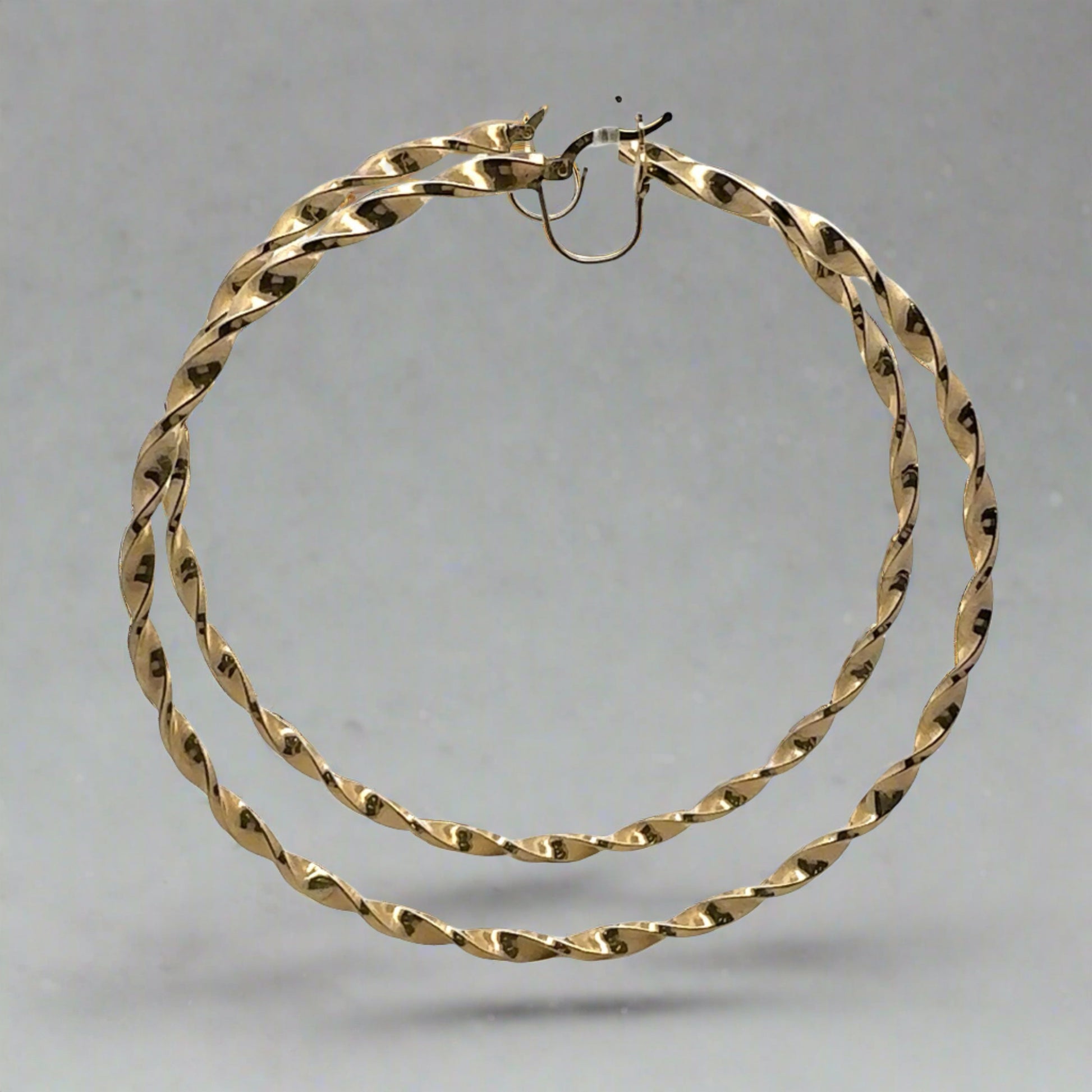 Side of Twist hoops in yellow gold