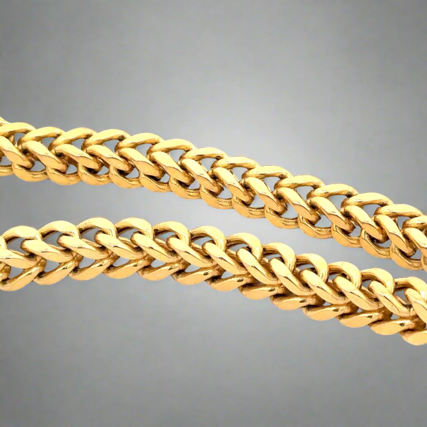 Another close up of square yellow gold franco chain links