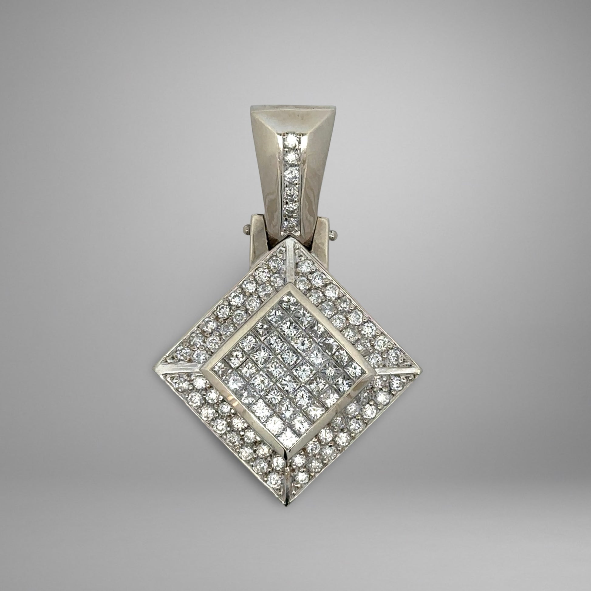 Diamond-encrusted pendant on a gray background with princess-cut and round diamonds