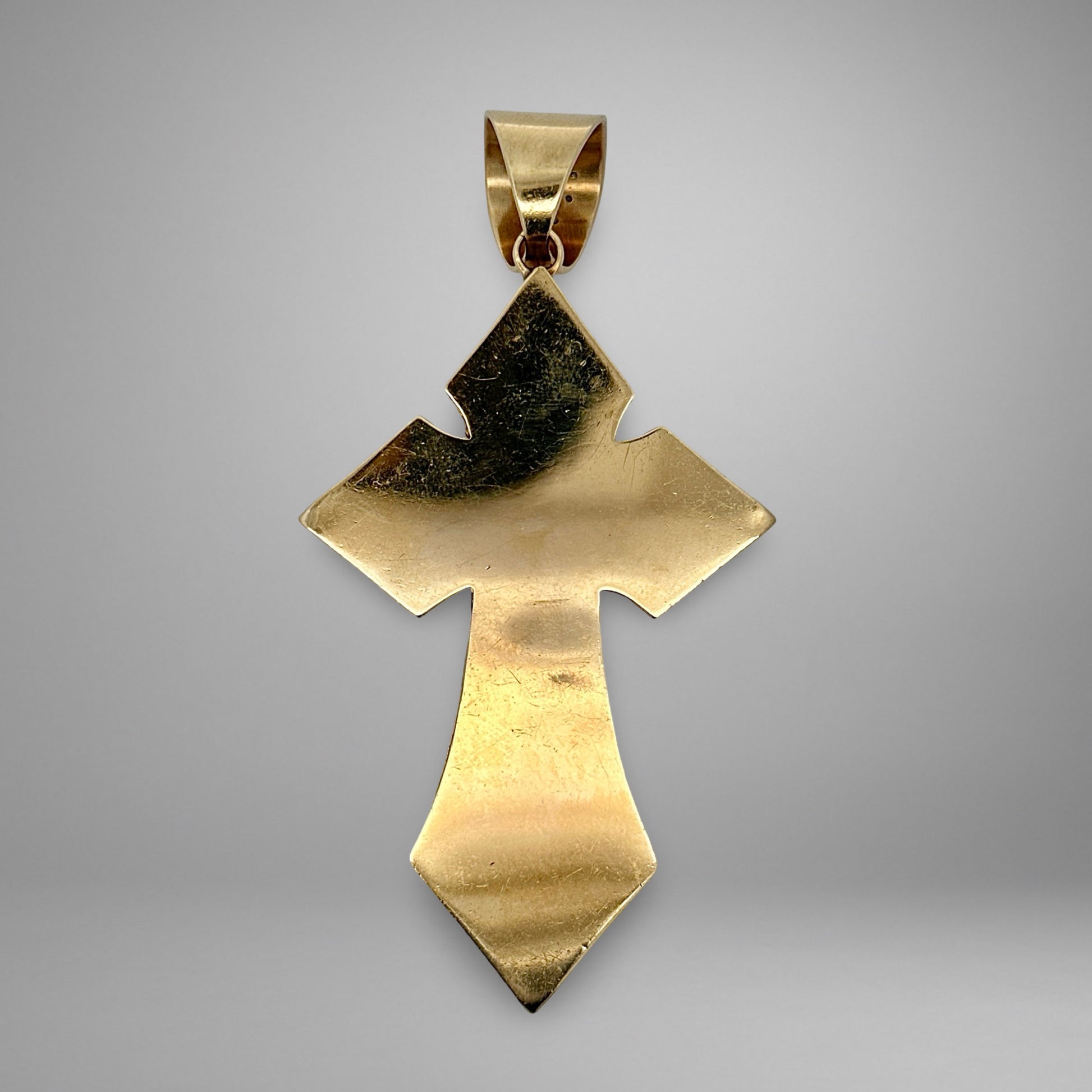 Yellow gold cross pendant with scratches on back