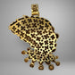 Back of gold pendant with intricate floral design on a gray background