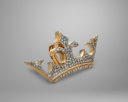 Gold crown with diamonds on a gray background