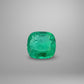 Cushion-shaped emerald on a gray background