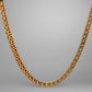 Gold necklace on a gray background
