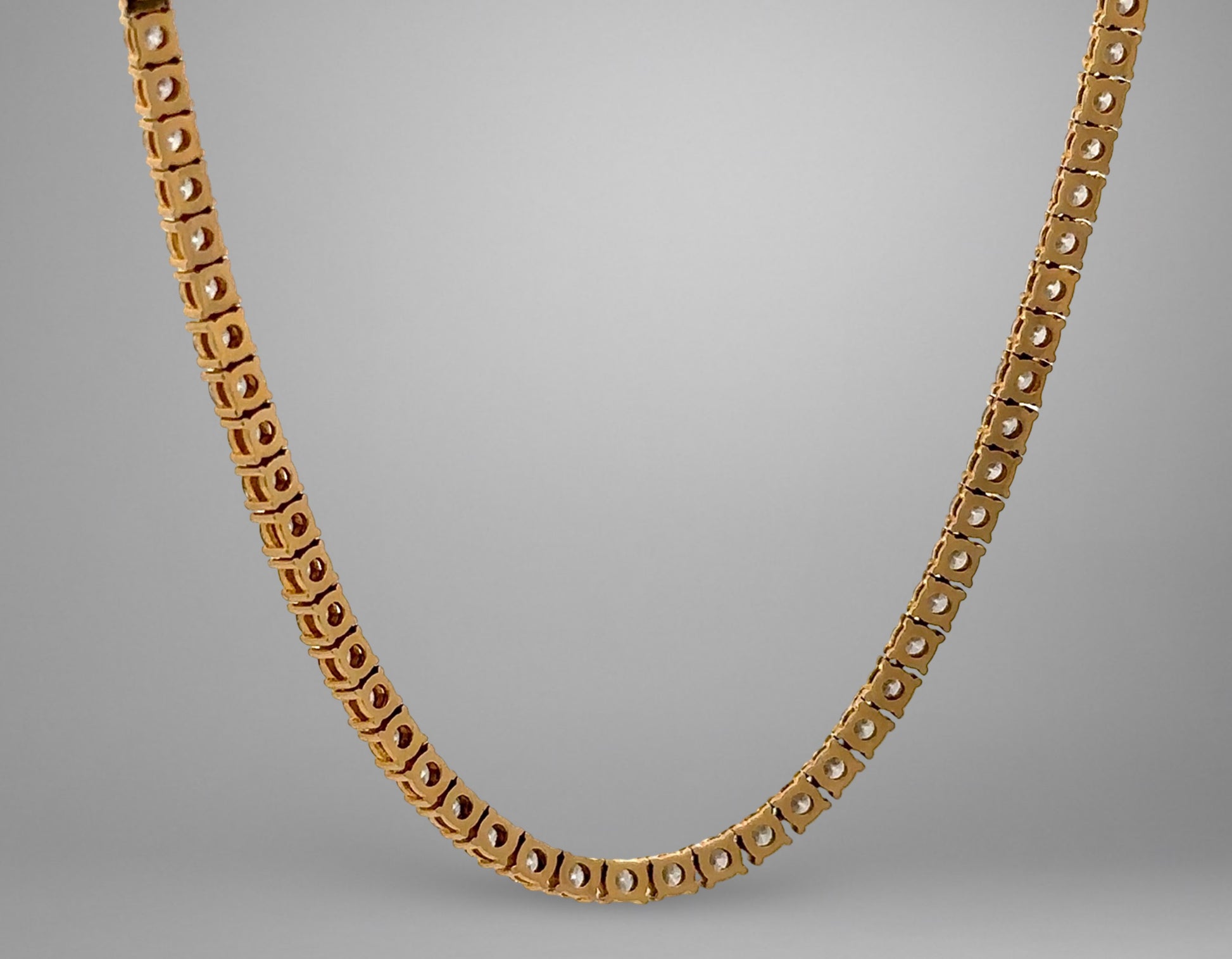 Gold necklace on a gray background