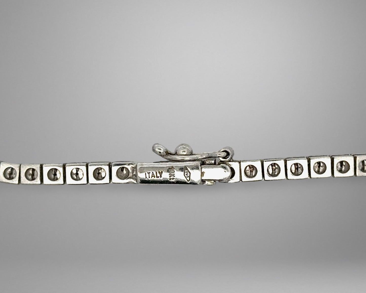 White gold clasp with 18K stamp and 1 safety lock