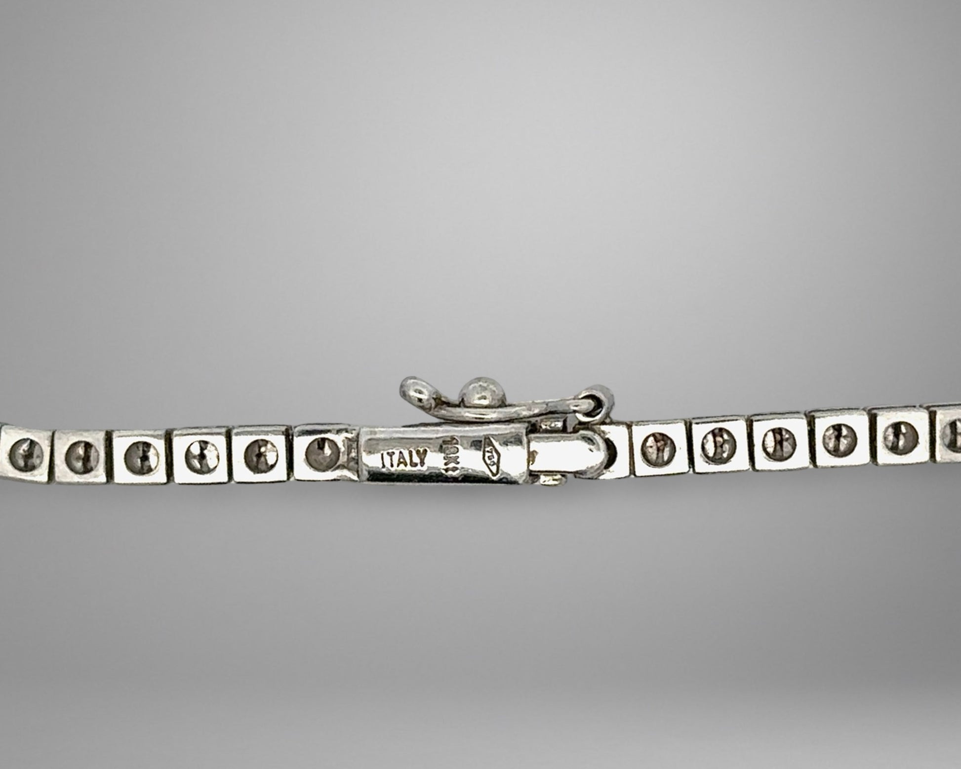 White gold clasp with 18K stamp and 1 safety lock