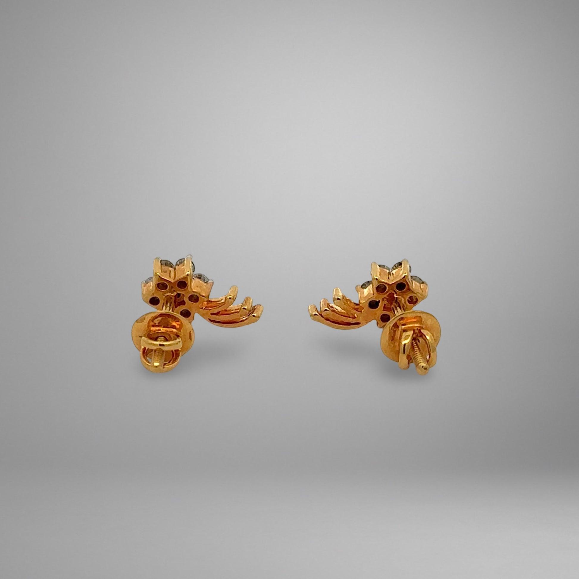 Pair of gold earrings on a gray background
