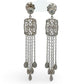 White gold diamond chandelier earrings with intricate designs on a white background