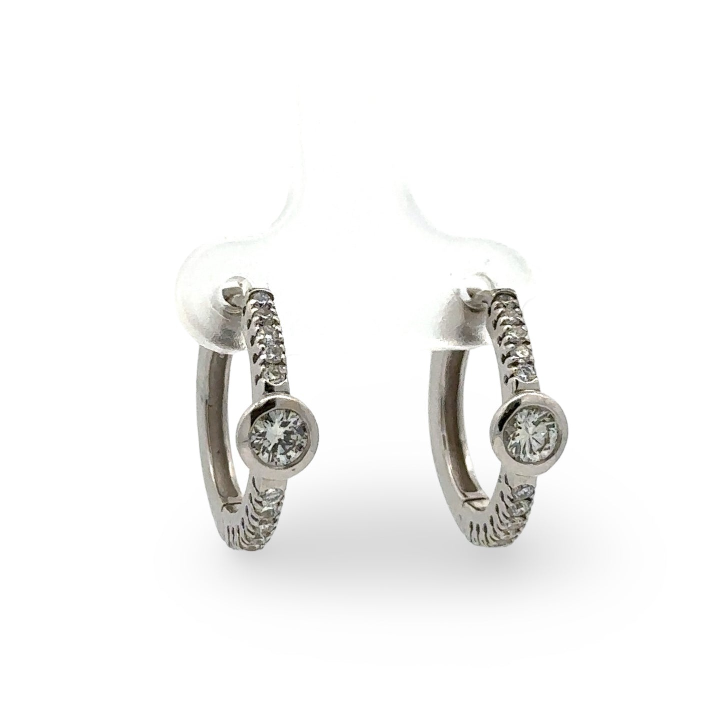Pair of white gold diamond hoop earrings  on a white background