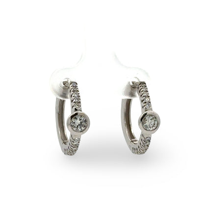 Pair of white gold diamond hoop earrings  on a white background