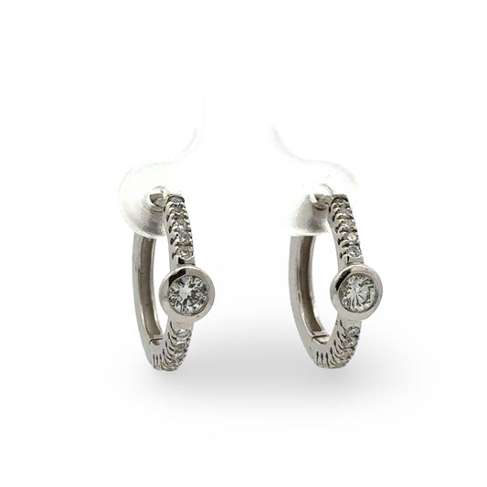 Pair of white gold diamond hoop earrings  on a white background