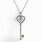 white gold key shaped pendant on a thin chain with attached hearts