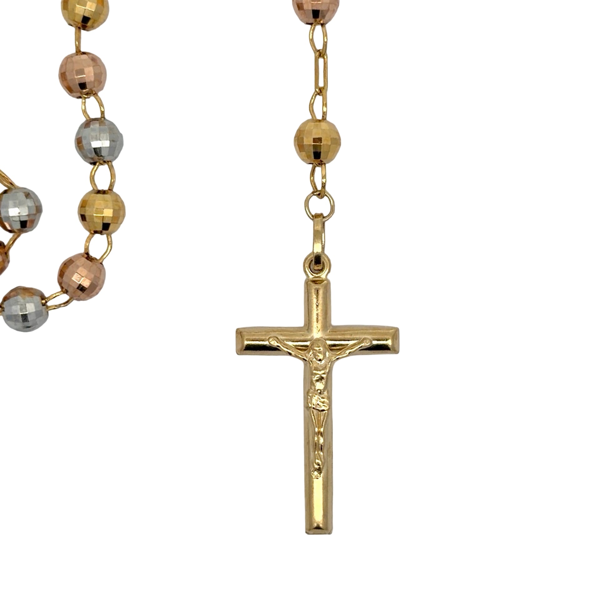 Close up of yellow gold crucifix on white background