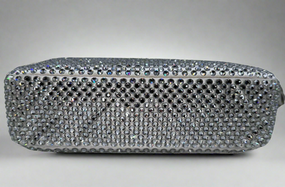 Pictured: The bottom of the Prada Crystal satin mini bag re-edition in white covered with crystals. No imperfections.