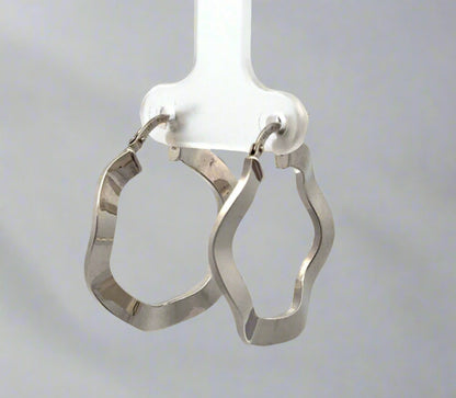diagonal view of white gold wavy hoops