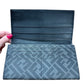 Interior flaps of wallet with 8 card slots on grey textured FF material + 4 card slots on other side of flap + 1 inner pocket