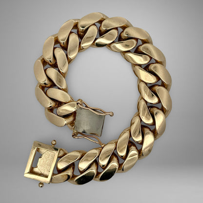 Gold bracelet on a gray background