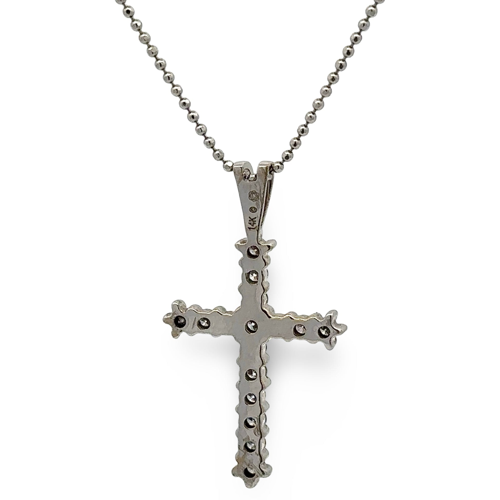white cross pendant necklace on a white background