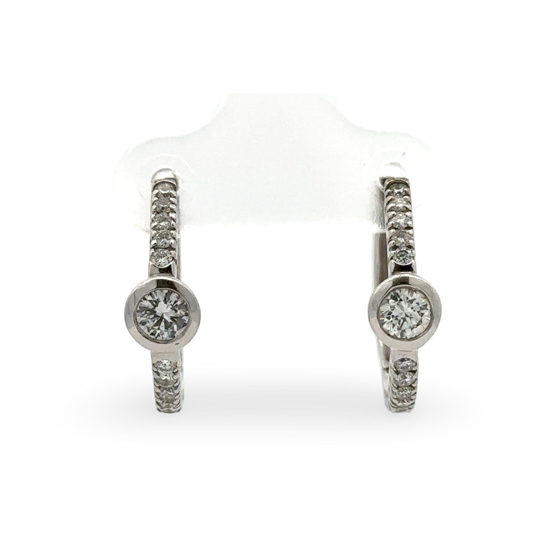 Pair of diamond hoop earrings on a white background